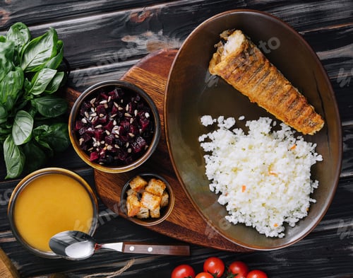 Preview: Roast fish with white rice on a cutting board