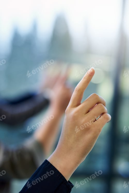 Hand Touching an Interactive Display Screen Indoors