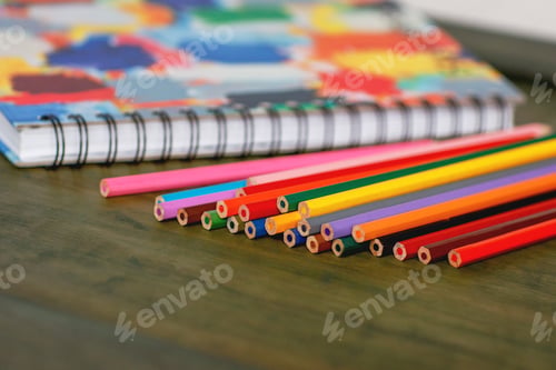 Preview: Color pencil and sketchbook on wood table