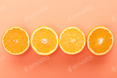 Preview: Top view of cut citrus fruits on orange background