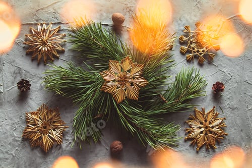 Preview: Homemade straw decor on Christmas tree close up. on a gray concrete background