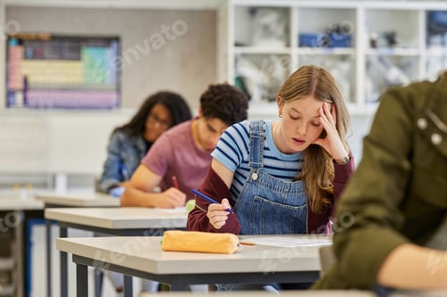 Preview: Student girl feeling stressed during exam at secondary school