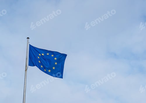 Preview: Flag of the European Union waving in the wind with a blue sky