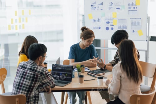 Preview: Team Discussing Graphs at a Business Meeting