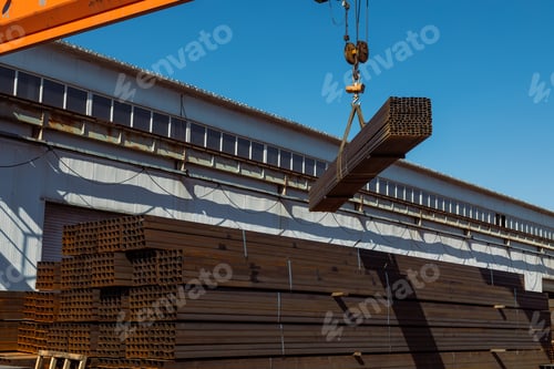 Preview: Gantry crane transporting stack of metal pipes