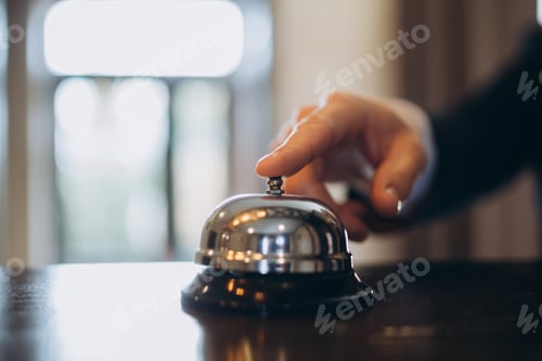 Preview: Arrival at the hotel. A man ringing a hotel reception service bell to attract attention.
