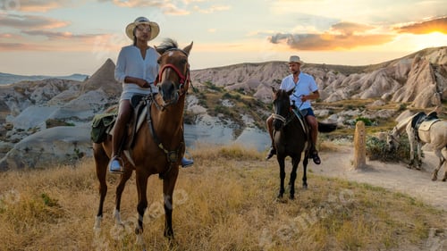 Preview: happy young couple on vacation Turkey Kapadokya horse riding in the mountains of Cappadocia Goreme