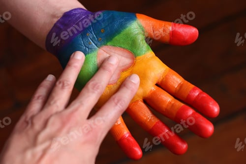Preview: Colorful painted hand touching