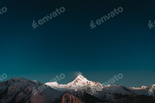 Preview: Georgia. Winter Night Starry Sky With Glowing Stars Over Peak Of