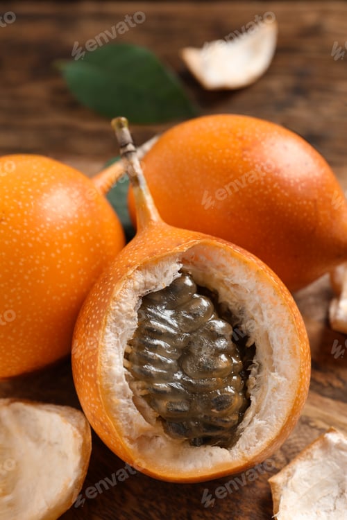 Preview: Delicious ripe granadillas on wooden table, closeup