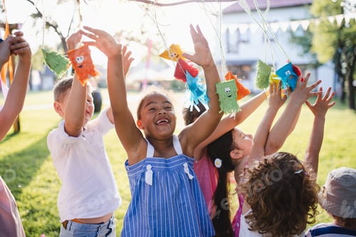 Preview: Small children standing outdoors in garden in summer, playing.