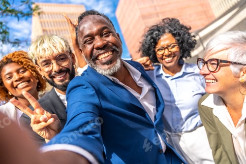 Preview: Happy elegant african businessman taking a selfie with coworkers