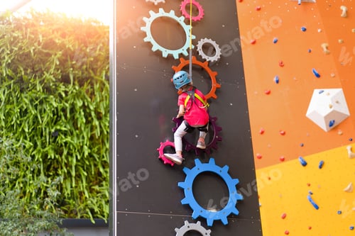 Preview: Child climbing on wall in amusement centre. Climbing training for children.
