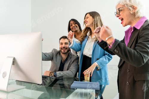 Preview: Diverse business team celebrating success watching computer screen