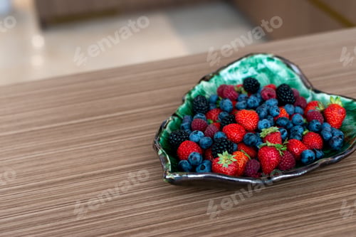 Preview: Designer plate with fresh raspberries, blackberries, blueberries, strawberries on a bed. Healthy bre