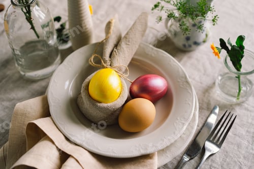 Preview: Happy Easter. Stylish easter eggs on a napkin with spring flowers on white wooden background