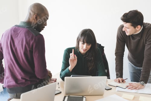 Preview: Multiracial business people working together connected tablet and notebook