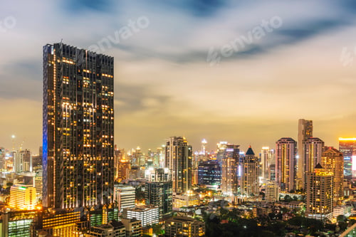 Preview: Modern hight building in business city center of Bangkok with moving cloud in the sky at night.