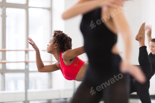 Preview: Young women in dance studio dancing, differential focus