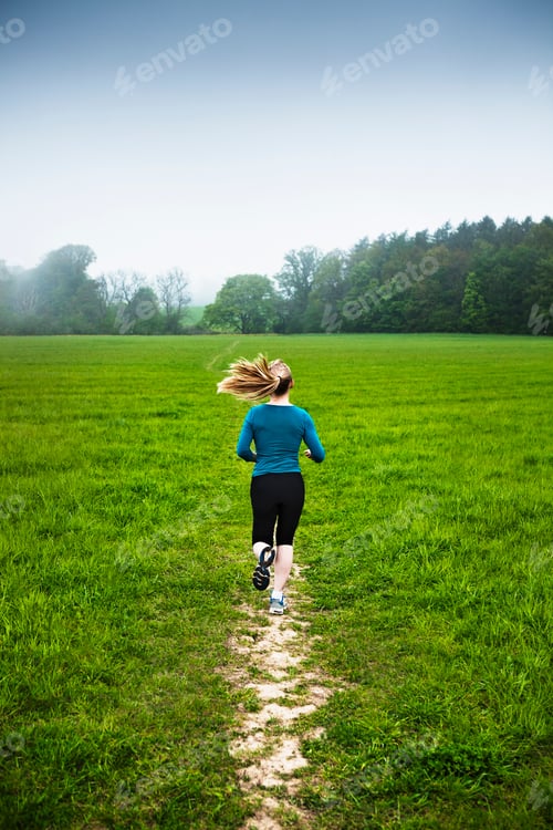 Preview: Mature woman running in countryside