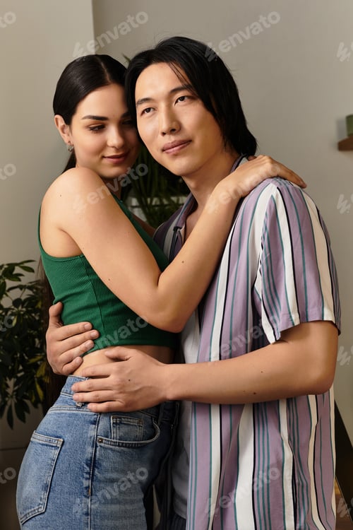Preview: Couple embraces warmly in their cozy home, sharing a moment of love and connection