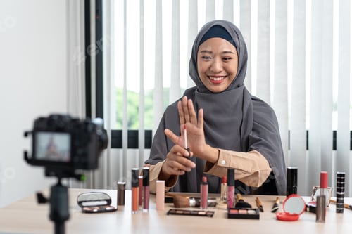 Preview: Woman Muslim blogger is showing present make up tutorial beauty cosmetic review product and live