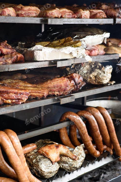 Preview: A large grill is used to cook different types of meat and vegetables. Street Food Festival.