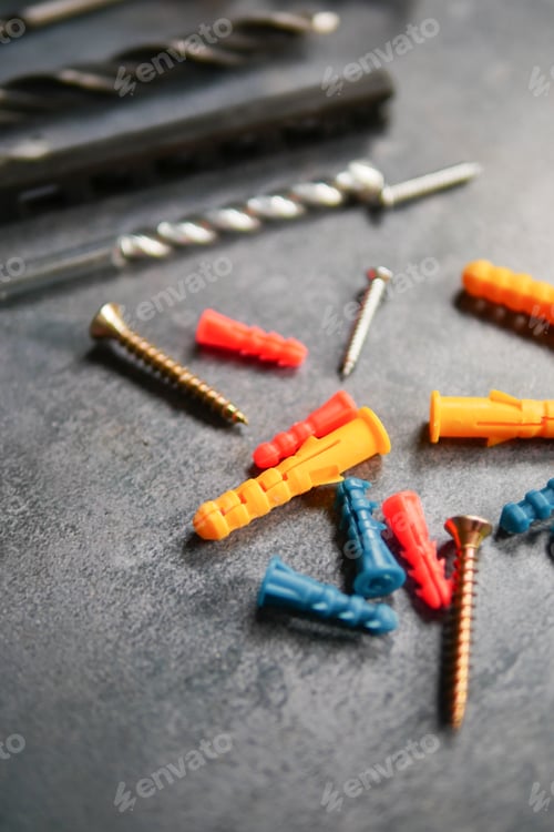Preview: Colorful screws and plugs on a workbench during repairs