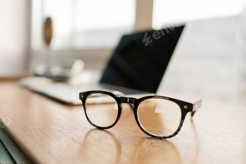 Preview: glasses for computer, laptop and tablet on the table, financial report