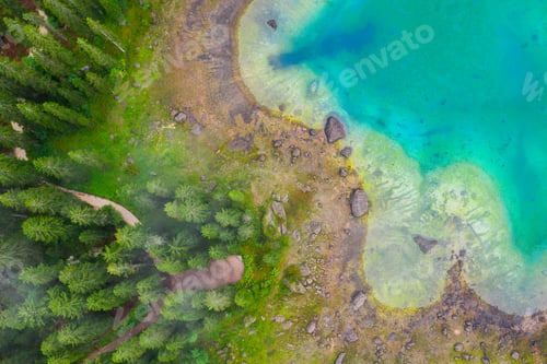 Preview: Aerial view of turquoise blue water of lake Carezza in Alps Dolomites. Lago di Karersee near fir