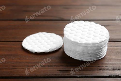 Preview: Stack of cotton pads on wooden background