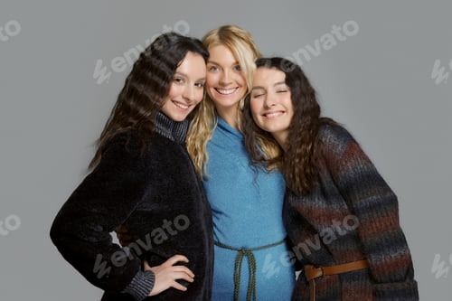 Preview: Happy smiling friends. Three attractive girls in woolen coats.