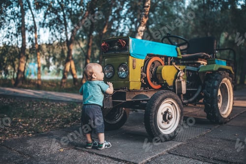Preview: kid studying tractor on the farm
