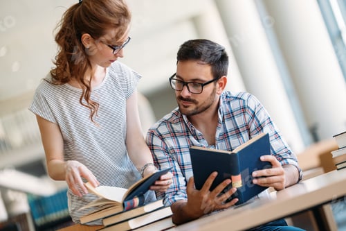 Preview: Young attractive students spending time in library