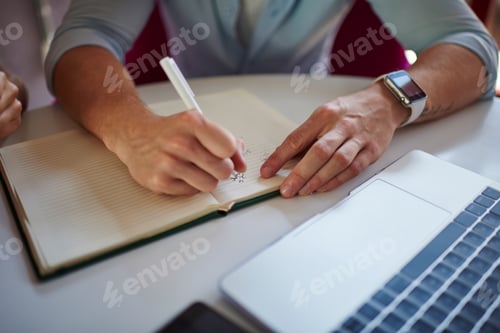 Preview: , cropped image of skilled man with laptop computer and notepad e learning in university doing homew