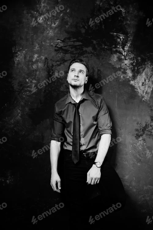 Preview: Studio portrait of stylish man, wear on blue shirt and necktie.