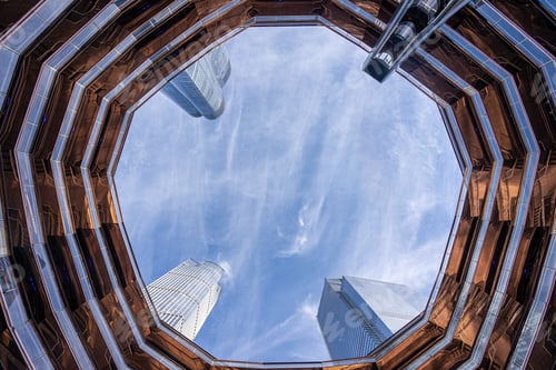 Preview: Low angle of an urban high building at Hudson Yards under high skyscrapers and cloudy sky