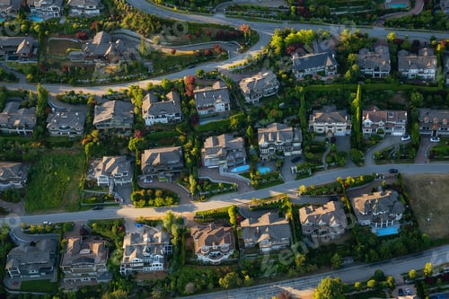 Preview: Aerial view of the big luxury homes on the hill during a vibrant sunny summer day