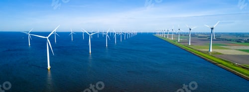 Preview: A picturesque scene of numerous windmills scattered across a vast body of water ocean