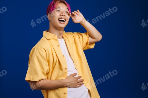 Preview: Asian boy with pink hair laughing and looking aside
