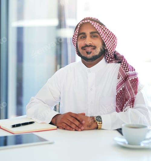 Preview: Portrait of a confident young muslim businessman working at his desk in a modern office