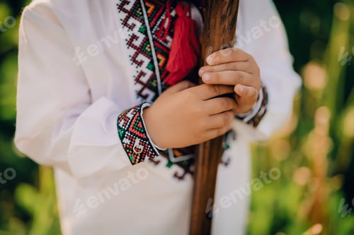 Preview: Portrait of little boy with woodwind wooden flute - ukrainian sopilka. Folk music concept. Musical