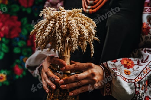 Preview: Ukrainian woman in authentic costume with Didukh on colorful ornaments carpet.
