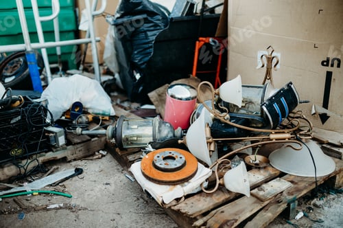 Preview: Collection of old and used household goods scattered around in the recycling center