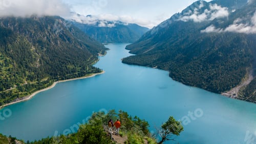 Preview: Exploring the breathtaking views of Plansee Lake surrounded by majestic mountains in Austria