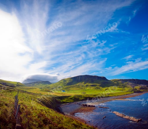 Coastal Vista of Rolling Green Hills Meets Azure Sea