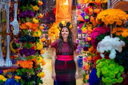 Preview: Latina with catrina walks through Día de Muertos decorations at Coyoacán market in Mexico City