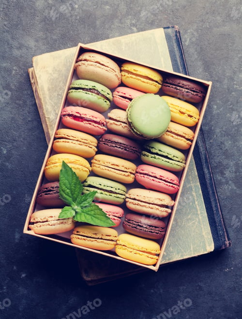 Preview: Colorful macaroons in a box over book