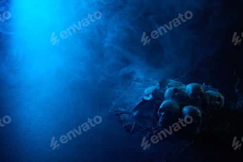 Preview: Halloween human skulls in abstract smoke on black background.