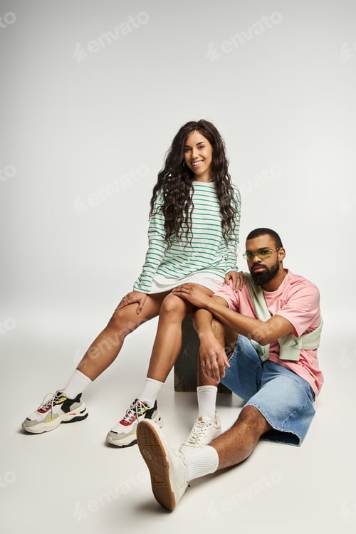 Preview: Stylish couple enjoying a moment of connection in a chic, minimalist studio setting